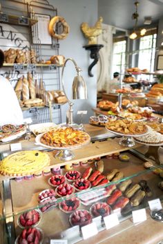 a man standing in front of a counter filled with lots of food