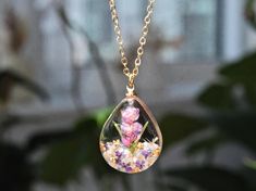 This necklace features Gladiolus, the birth flower for August, carefully preserved in a clear resin pendant. Gladiolus is symbolic of strength of character, faithfulness, moral integrity, and remembrance, making this necklace a perfect personalized birthday gift. Material: 14k gold filled chain and components or Silver, Resin Flower: Real Pressed Flower Chain Length: 18" (45cm)  Pendant Width: 0.79" (2cm) Pendant Height: 0.98" (2.5cm) Every pieces is made by hand and unique, therefore each piece Spiritual Necklaces With Pressed Flowers As Gift, Spiritual Style Necklace With Pressed Flowers As A Gift, Memorial Flower Pendant Necklace With Birth Flower, Memorial Birth Flower Pendant Necklace, Memorial Birth Flower Jewelry, Clear Flower-shaped Birth Flower Jewelry, Clear Flower Shaped Birth Flower Jewelry, Nature-inspired Clear Jewelry For Gifts, Clear Nature-inspired Jewelry For Gift