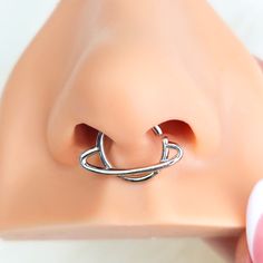 a close up of a fake nose with a ring on it