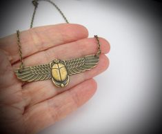 "Vintage design Egyptian Revival Scarab Pendant Necklace. Beautiful Antiqued brass. Ornate detailed Scarab, 2-3/8\" across. Antiqued brass finish brass chain with a lobster clasp. Handmade by me, on Maui, and sent to you with Aloha! #53 More of my Artisan Jewelry: hawaiibeads.etsy.com" Scarab Pendant, Egyptian Revival, Art Deco Necklace, Swarovski Pearls, Brass Chain, Style Gift, Birthday Anniversary, Brass Finish, Artisan Jewelry