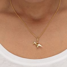 Celebrate a roarsome birthday with this stunning gold plated origami t-rex charm necklace. This three-dimensional dinosaur charm mimics folds of paper to resemble the Japanese art of paper folding, known as origami. Crafted from 18ct gold plated silver, it features smooth polished surfaces for a high-quality shine and has stunning geometric look. An on-trend design, this Tyrannosaurus Rex pendant makes for a quirky jewellery gift to symbolise power, strength and bravery.  All our charms attach w Origami T Rex, Origami Jewellery, Matching Jewellery, Quirky Jewelry, Origami Jewelry, Art Japonais, Matching Jewelry, Tyrannosaurus Rex, Demi Fine Jewelry