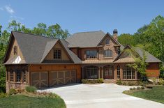 a large house with two garages and lots of windows