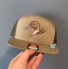 Expertly crafted for waterfowl pintail duck hunters, this Richardson 168 Hat/Cap features a beautifully embroidered pin-tailed duck design. Made with high-quality materials, it makes the perfect gift for any avid duck hunter. Stay stylish and comfortable on your next hunting trip with this must-have accessory. 60/40 cotton/polyester, twill 100% polyester mesh back Structured, seven-panel, Hi pro profile Flat bill Adjustable snapback closure This is a physical product. This product is unisex. Thi Pintail Duck, Hunter Design, Rhinestone Hoodie, Duck Hunter, Patriotic Outfit, Hunting Trip, Hat Cap, Embroidered Patches, Trucker Cap