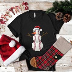 Swing into the festive spirit with our unique Baseball Santa Snowman design! Ideal for baseball enthusiasts, this tee melds the essence of your favorite sport with the jubilance of Christmas. Whether on the field or joining a holiday festivity, showcase your passion with this standout attire. * Please do not hesitate to contact the shop with any questions.  * Not all available colors can be listed in the color dropdown. The size charts include all color variations per style. If you want a color not in the dropdown just select black & type in the color in the order comments. We will refund if we don't have the color in stock. * Want the design printed on the back? Just add this request to the order comments box at checkout! * If you need to cancel an order please reach out as soon as possib Baseball Santa, Baseball Snowman, Men Tees, Stylish Tank Tops, Long Sleeve Kids, Funny Xmas, Christmas Funny, Hooded Sweatshirt Men, Christmas Hoodies