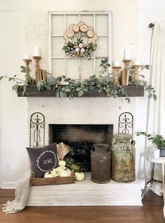 a living room filled with furniture and a fire place covered in greenery on top of a mantle