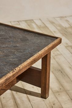 a wooden table sitting on top of a hard wood floor