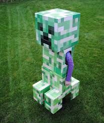 a person in a minecraft creeper costume standing on some blocks with their head down