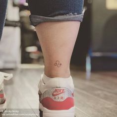 a woman's foot with a small tattoo on her left ankle and the word love is written across it