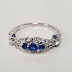 "Thanks for shopping our vintage estate store. We tend to sell well below wholesale and truly hope you enjoy all of our items. Many of the items are one of a kind, so please enjoy scrolling through the pictures and hopefully something will catch your eye. Nice estate sterling silver 925 created or synthetic sapphire .50ct cz diamond cocktail ring. Just stunning. Custom made from our shop. Retails $89 on sale $39 Ring size: please select a size Setting: 5/8\" 14mm by 1/4\" 6mm Band weight: 2mm We Blue Oval Stackable Rings For Anniversary, Sapphire Cluster Ring With Diamond Accents For Anniversary, Vintage Blue Cubic Zirconia Rings, Classic Sapphire Cluster Ring For Anniversary, Blue Cubic Zirconia Stackable Rings For Anniversary, Anniversary Blue Cubic Zirconia Stackable Rings, 14k White Gold Sapphire Diamond Ring For Anniversary, Sapphire Diamond Ring With Round Band For Anniversary, Anniversary Sapphire Stackable Rings In Oval Shape