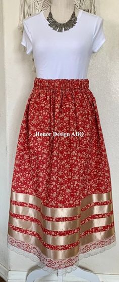 "Traditional Ribbon Skirt red, beige prairie floral print, accented with beige satin and ivory lace ribbon.  Finished with elevated  details and lovingly made by hand. A paper bag waist hugs the body, while also being comfortable to wear. See our sizing details below to find your perfect size.  Ready to ship! A long time symbol femininity, sisterhood and solidarity, used in ceremony and everyday, every skirt tells a story written by the woman who wears it. Perfect for every season, dressed up or Native American Ribbon Skirts, Ribbon Skirts Pattern, Ribbon Skirts Native American, Crochet Ribbons, Time Symbol, Powwow Outfits, Ribbon Clothing, Native Outfits, Indigenous Studies