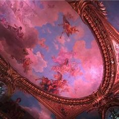 an ornate ceiling with paintings on it and gold trim around the edges is painted in blue, pink, and white