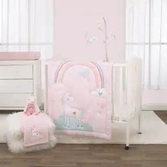 a baby's room with white furniture and pink walls, including a teddy bear crib