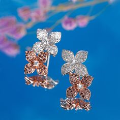 A brilliant addition to any fine jewelry lover, these double floral earrings are modern, feminine and eccentric. Each earring contains a larger floral with a smaller one placed behind it, making it seem as if the delicate flowers are climbing up your earlobe. Each flower is made up of sterling silver and decorated with white and chocolate stones.Carat Weight: 3.095 ctStone Size: 1,1.2,2,1,1.2,0.8,0.8 mmStone Type: Jeulia® StoneNumber of Stones: 270 Stone Shape: RoundStone Color: Diamond White, C Elegant Flower Hoop Earrings For Anniversary, Flower Shaped Evening Jewelry With Matching Earrings, Rose Gold Flower Jewelry For Evening, Luxury Flower Cluster Earrings As Gift, Luxury Flower Cluster Earrings For Gift, Luxury Flower Shaped Pierced Earrings, Elegant Rose Gold Hoop Earrings With Flower Shape, Elegant Flower Hoop Earrings With Flower Charm, Fine Jewelry Rose Gold Flower Earrings