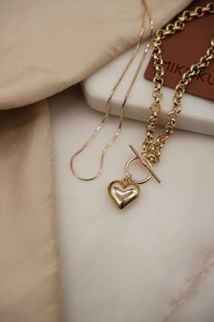 Details: - 14K Gold Plated Heart Toggle Necklace - 18K Gold Filled Dainty Snake Chain - Heart pendant:  Size: 15x17mm Material: 14k gold plated. - Toggle clasp: Gold Plated. Toggle Bar: 25mm Toggle Outer Ring: 15mm and Inner Ring: 11mm Combo A: 14" dainty snake chain 16" heart toggle necklace Combo B: 16" dainty snake chain 18" heart toggle necklace Combo C: 18" dainty snake chain 20" heart toggle necklace Combo D: 20" dainty snake chain 24" heart toggle necklace To obtain the individual necklac Valentine's Day Gift Jewelry With Toggle Clasp, Gold Necklaces With Toggle Clasp For Wedding, Tarnish Resistant Round Toggle Necklace Gift, Yellow Gold Chain Necklace With Toggle Clasp Gift, Yellow Gold Jewelry With Toggle Clasp Gift, Valentine's Day Jewelry Gift With Toggle Clasp, Gold Plated Chain Necklace With Toggle Clasp As Gift, Tarnish Resistant Round Toggle Necklace For Gift, Elegant Toggle Necklace For Valentine's Day Gift