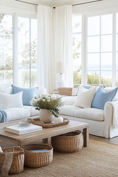 a living room filled with white furniture and lots of window sill space in front of the windows