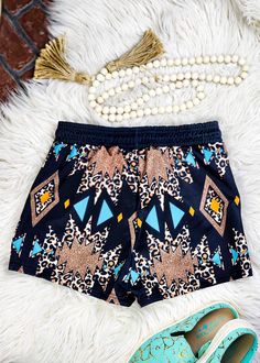 These Leopard Aztec Drawstring Shorts make a bold statement with their unique bling and cowgirl-inspired style. Stay cool and stylish this summer in these one-of-a-kind shorts! Who says fashion can't be fun? 95% polyester and 5% spandex Regular fit True to size - size chart available in photos Care Instruction: machine wash cold with similar colors, do not bleach, tumble dry low, do not iron, do not dry clean. This item ships in 14 +/- days. Stretch Beachwear Shorts For Festival, Summer Festival Swimwear, Multicolor Short Swimwear For Festival, Summer Festival Stretch Bottoms, Stretch Bottoms For Summer Music Festival, Stretch Festival Bottoms, Beachwear Bottoms With Built-in Shorts For Festival, Bohemian Stretch Shorts For Festivals, Fitted Shorts For Summer Music Festival