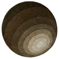 four round rugs in various colors on a white background