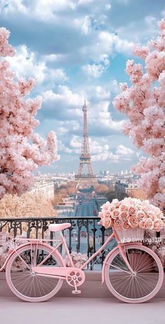 a pink bicycle with flowers in front of the eiffel tower