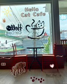 there is a cat cafe in the window with cats drawn on it's windowsill