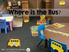 there is a classroom with tables and chairs in the room, which has words where is the bus?