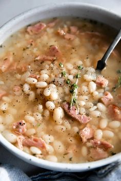 a bowl filled with white beans and ham