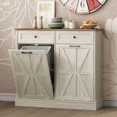 a white cabinet with two doors and a clock on the wall in front of it