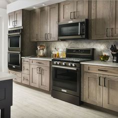 a kitchen with wooden cabinets and stainless steel appliances