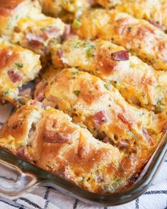 a casserole dish with ham and cheese in it sitting on a tablecloth