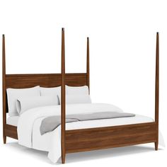 a bed with four posts and white sheets