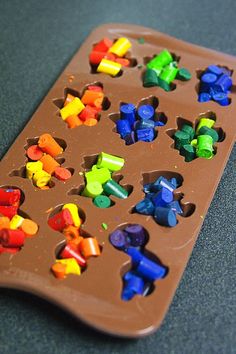 a chocolate tray filled with lots of different colored candies on top of a table