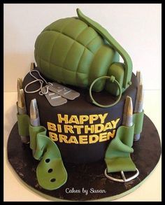 a birthday cake made to look like an army helmet and some green items on top