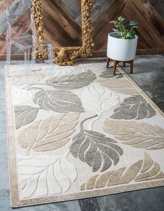 a rug with a plant on it in front of a mirror