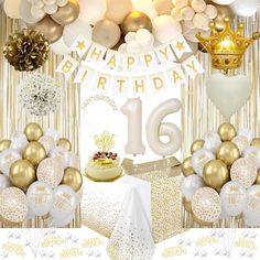 an image of a birthday party with gold and white decorations on the ceiling, balloons, cake and streamers