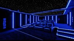 a home theater with blue lights in the ceiling and black carpeted flooring on the walls