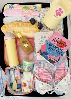 an open suitcase filled with baby items and personal care products, including sunscreens