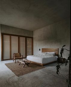 a bedroom with concrete walls and flooring