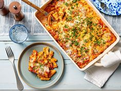 a casserole dish with meat and cheese in it on a plate next to a fork