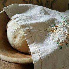 a piece of bread sitting on top of a wooden bowl