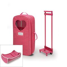 a pink luggage bag with a heart on it and a hand truck next to it