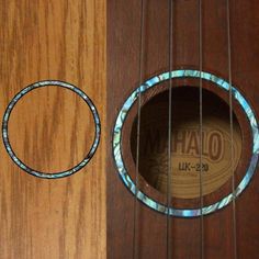 a close up of an acoustic guitar's frets and the hole in it