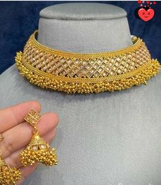 Add a touch of elegance to your attire with our stunning gold jewelry set. Indian, Bollywood style jewelry and includes a choker necklace and matching earrings. While the set might be considered a statement piece in western fashion, it is a rather minimalist set in Indian traditions. This beautiful set features a wide choker necklace and Jhumkis-inspired earrings, both adorned with delicate dangling pearls in gold. The whole jewelry is covered in yellow gold, giving a classic and elegant finish.  Gold is a timeless piece of jewelry, and this set will look elegant no matter the occasion. The gold jewelry can be paired with western and Indian attire, matched with a festival, evening party dress, saree, salwar suit, lenga, and more. Buy it for yourself or gift it, and makes a special gift to Gold Cutdana Jewelry Sets For Reception, Gold Jewelry Sets For Diwali Reception, Festive Gold-plated Bridal Necklace For Reception, Gold Meenakari Jewelry For Reception, Gold Bridal Sets With Cutdana For Reception, Elegant Gold Lehenga With Intricate Design, Gold Hand-set Lehenga For Reception, Gold Hand Set Lehenga For Reception, Diwali Gold Lehenga With Intricate Design