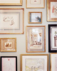 there are many framed pictures on the wall