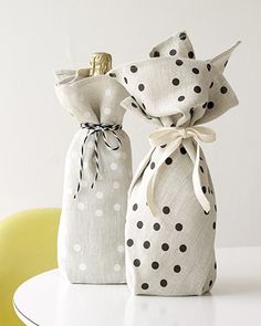 two bags with black and white polka dots are sitting on a table next to each other