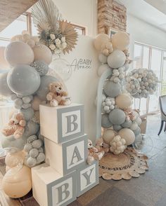 a baby shower with balloons and teddy bears on the top, along with other decorations