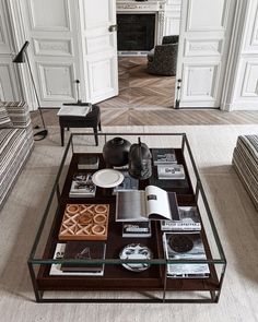 a coffee table with books and magazines on it