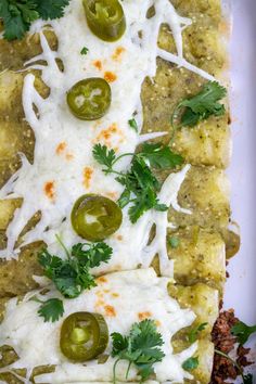 an enchilada is topped with cheese, sour cream and jalapenos