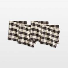 two black and white checkered napkins sitting on top of each other