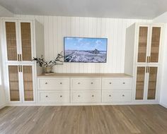 an empty living room with white walls and wood flooring