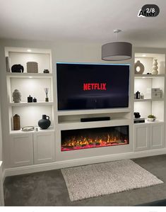 a flat screen tv mounted to the side of a wall next to a fire place