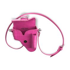 "Not a Gun Bag". Embossed calfskin pouch in pink. Adjustable shoulder strap with pin-buckle fastening. Magnetic press-stud tab fastening at flap. Bag and belt friendly top ring buckle. Snapped on belt loop at back. Logo at interior and back of the bag. Approx. 4.5" length x 5.5" height x 2" width. Pink Crossbody Shoulder Bag With Palladium Hardware, Pink Travel Shoulder Bag With Snap Closure, Pink Crossbody Shoulder Bag With Snap Closure, Pink Shoulder Bag With Snap Closure For Travel, Pink Shoulder Belt Bag For Mobile Phones, Pink Mobile Phone Belt Bag For Travel, Pink Pouch Belt Bag With Adjustable Strap, Top Rings, Press Studs